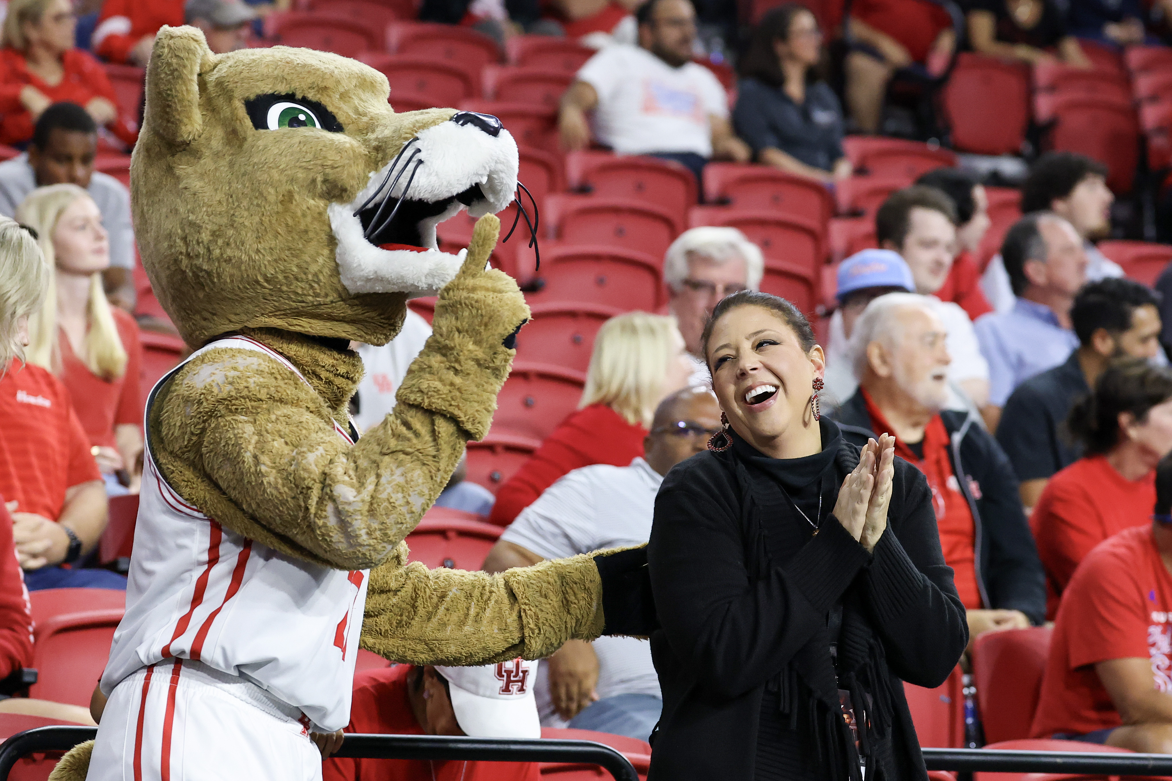 Kelvin's daughter Lauren Sampson, Houston men's basketball chief of staff, shares a moment with Shasta
