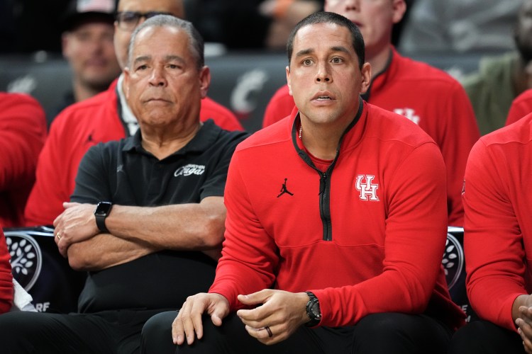 Father and Son: Head coach Kelvin Sampson and assistant Kellen Sampson look on from the Houston bench