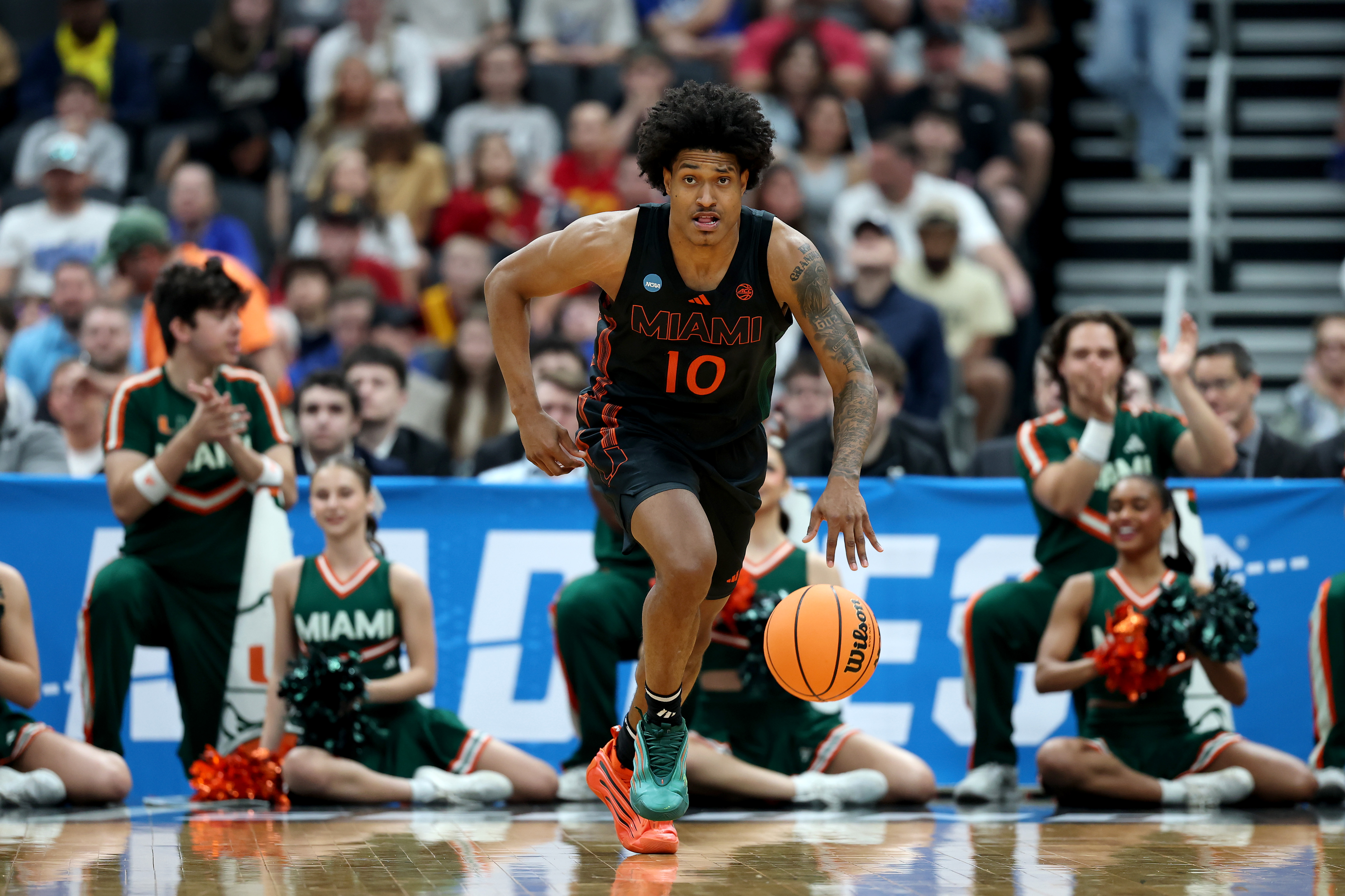 Tru Washington dribbles the ball up the court for Miami during a 2026 NCAA Tournament game against Purdue