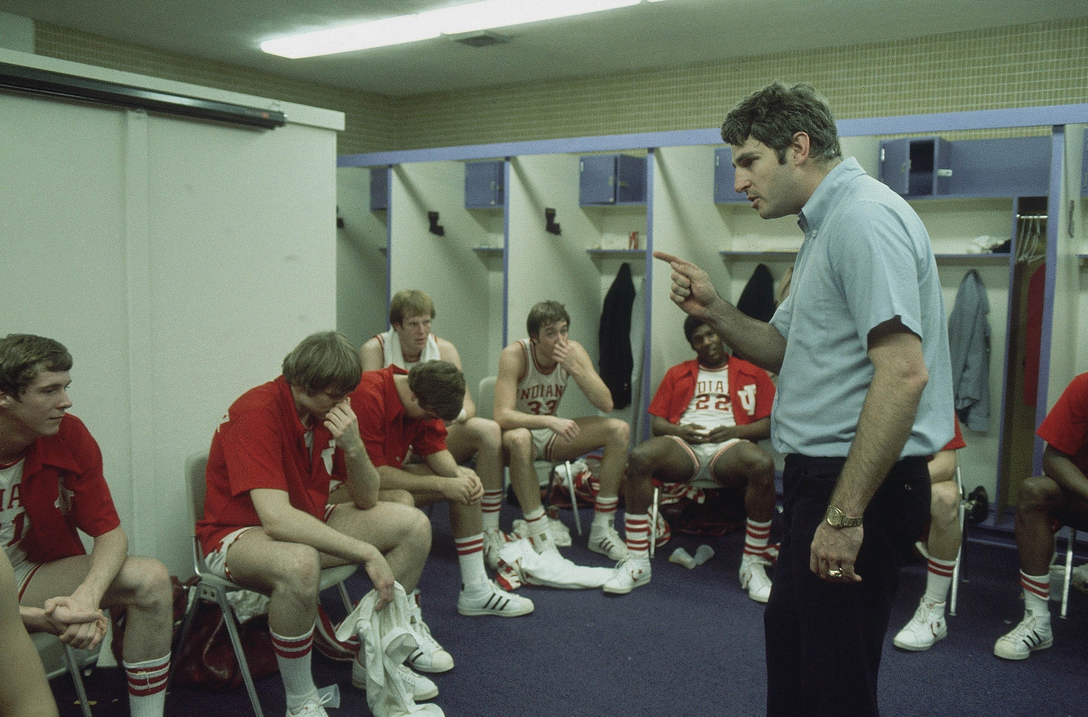 Bob Knight addresses his Indiana Hoosiers in a locker room during the 1976 NCAA playoffs