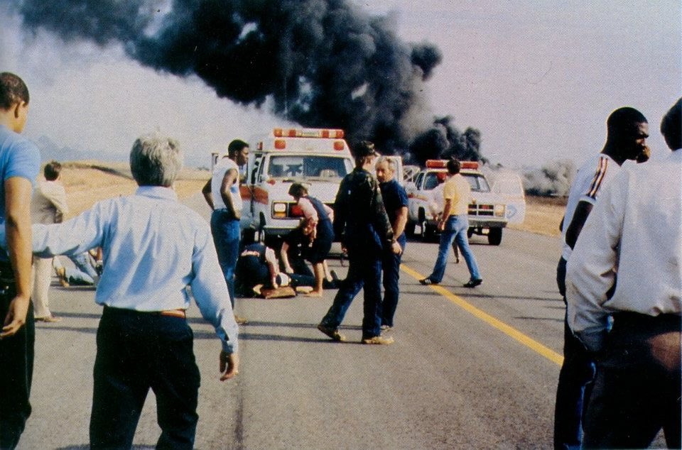 Paramedics attending to injured people after the ETSU plane crash. Smoke from the plane can be seen in the background.