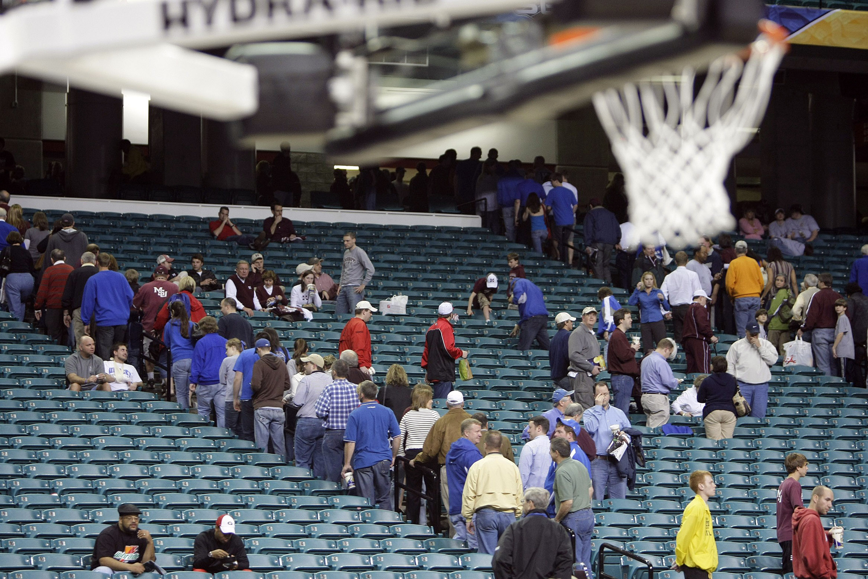 Spectators shuffle out of the Georgia Dome after the nightcap Kentucky-Georgia game was postponed due to severe weather
