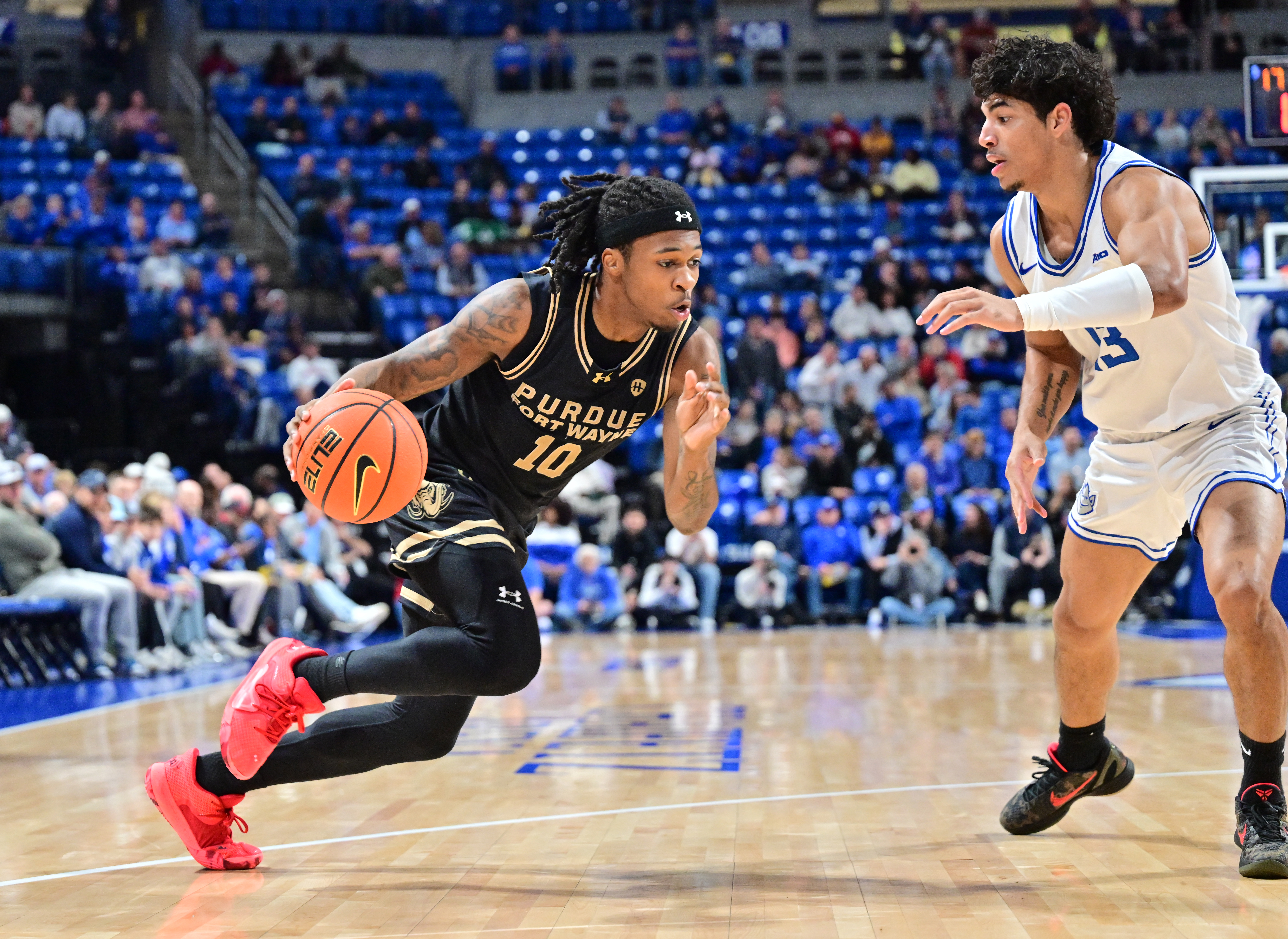 Corey Hadnot II of Purdue Fort Wayne attempts to dribble past Saint Louis guard Dion Brown