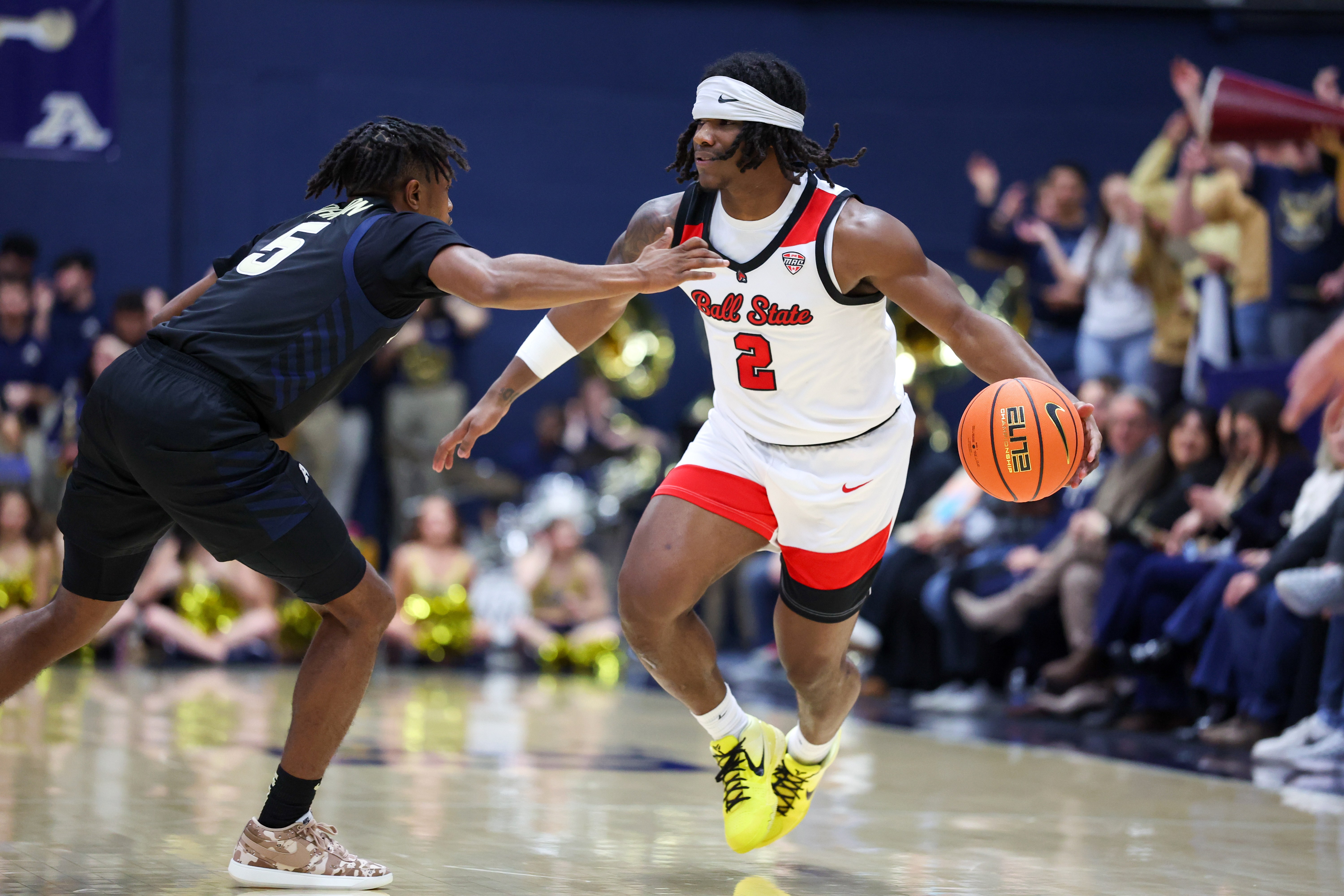 Ball State's Davion Hill dribbles the ball and attempts to get around an Akron defender