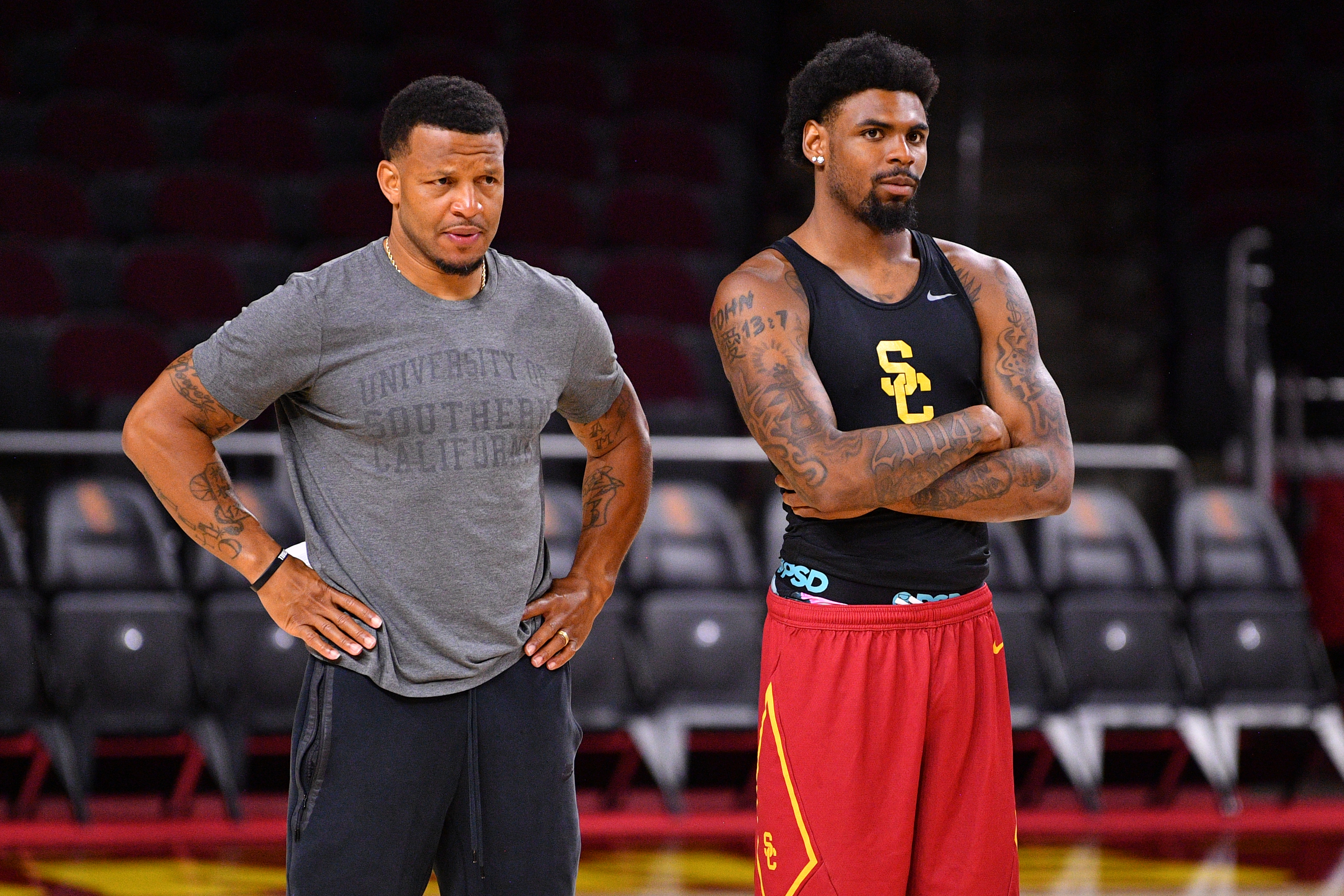 Trojans guard KJ Lewis and assistant coach Will Conroy look on during a 2026 summer practice session for USC