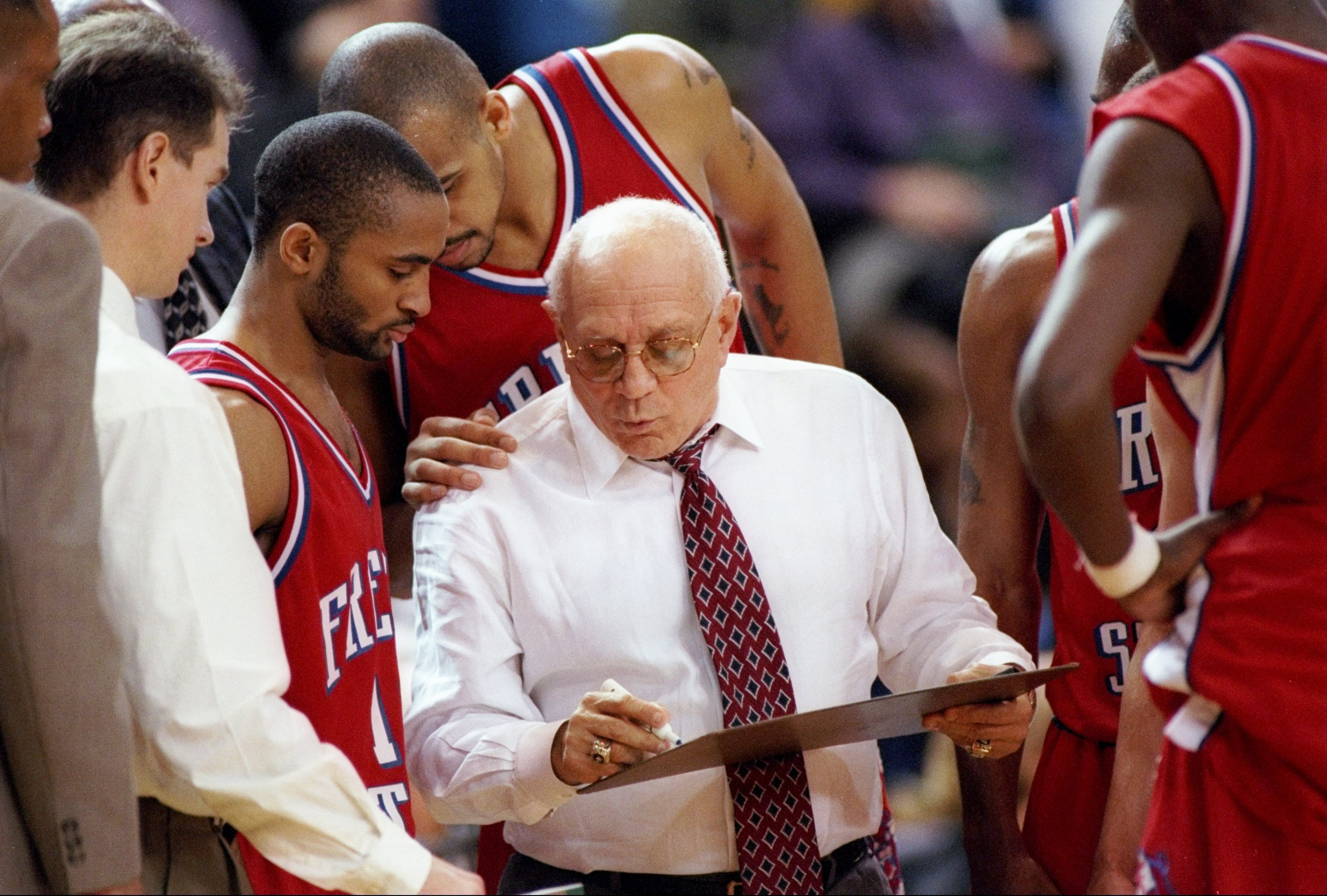 Fresno State coach Jerry Tarkanian confers with his players during a game against San Jose State