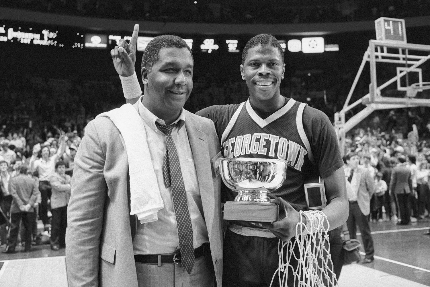22-year-old Patrick Ewing holds his Big East Tournament MVP trophy with Georgetown coach John Thompson