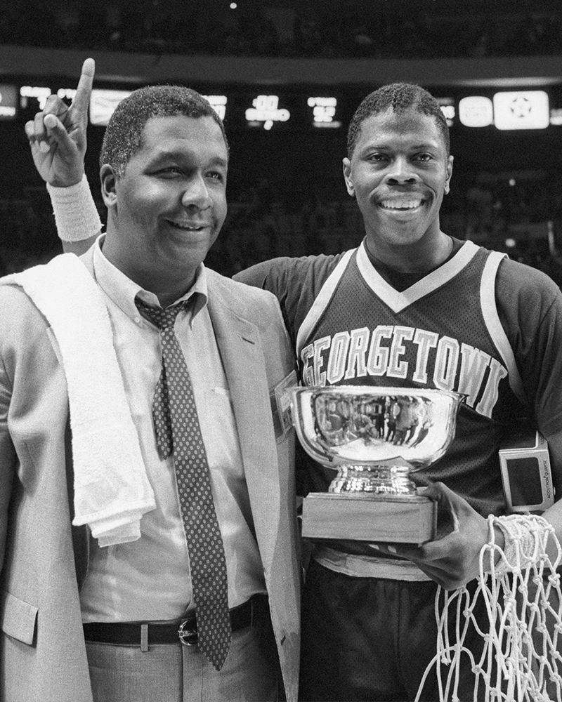 22-year-old Patrick Ewing holds his Big East Tournament MVP trophy with Georgetown coach John Thompson