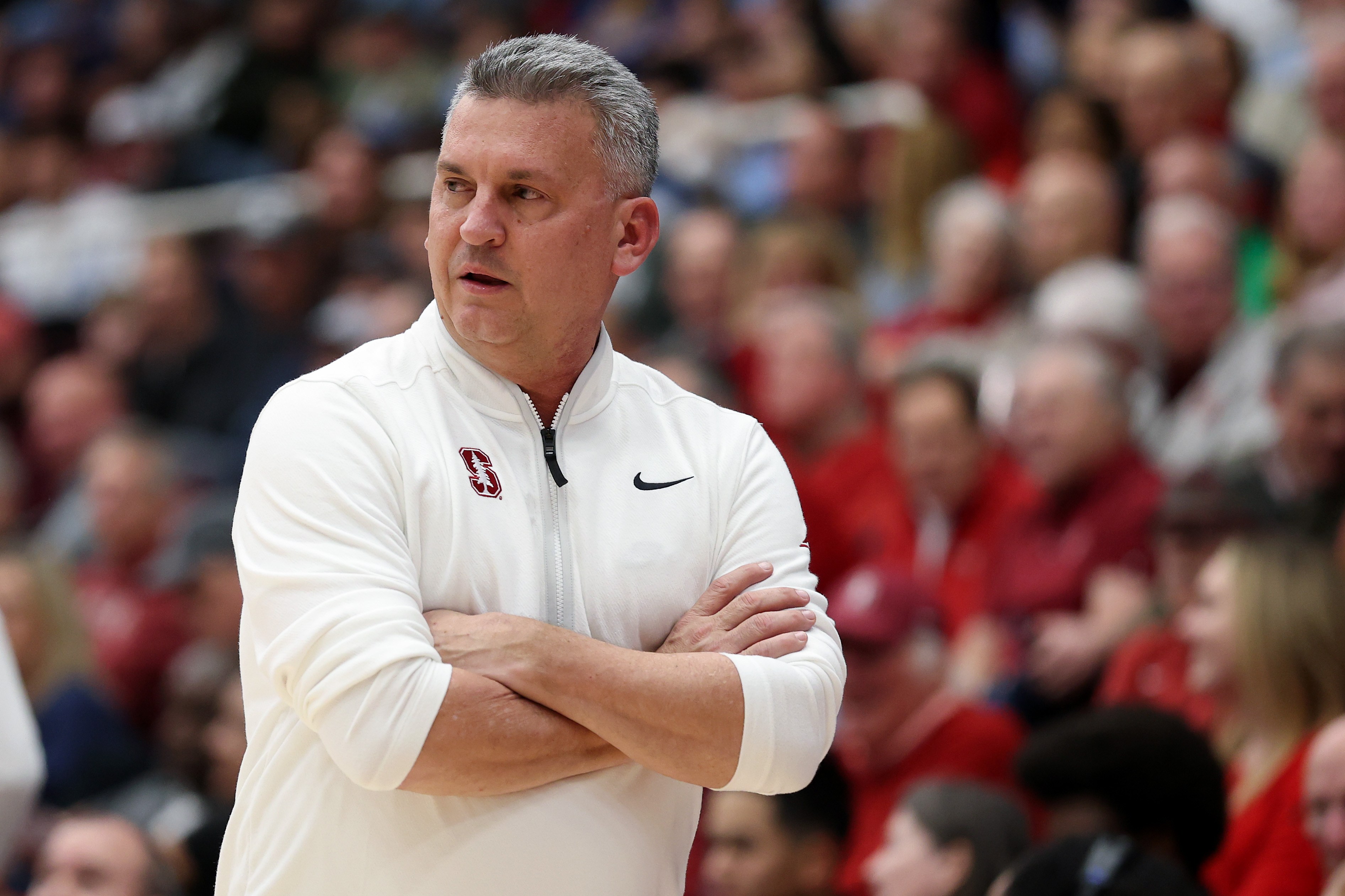 Stanford coach Kyle Smith with his arms crossed on the sidelines