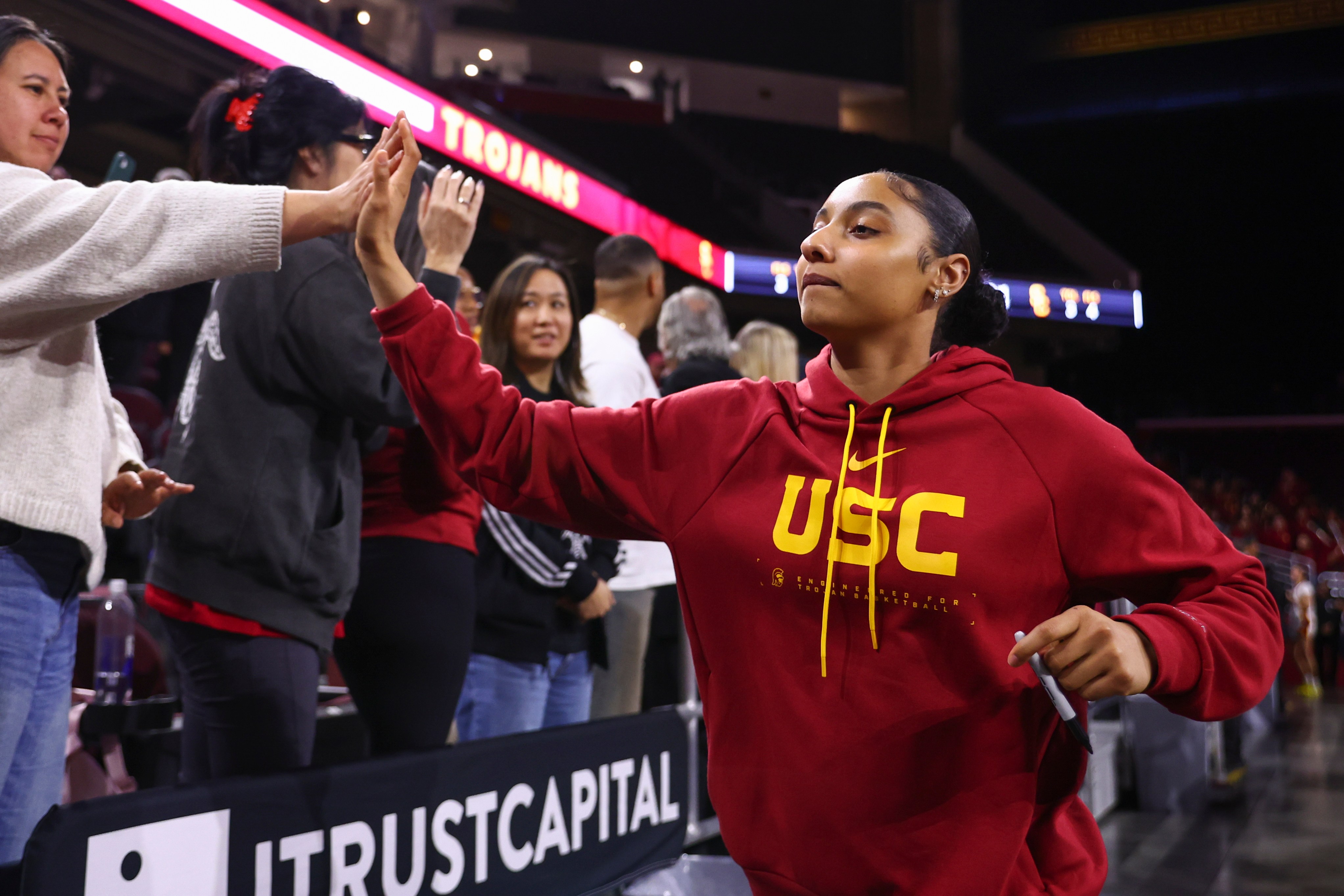 JuJu Watkins high fives fans during a 2026 game at the Galen Center