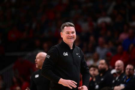 Arizona head coach Tommy Lloyd flashes a smile from the sidelines during a 2026 NCAA Tournament game
