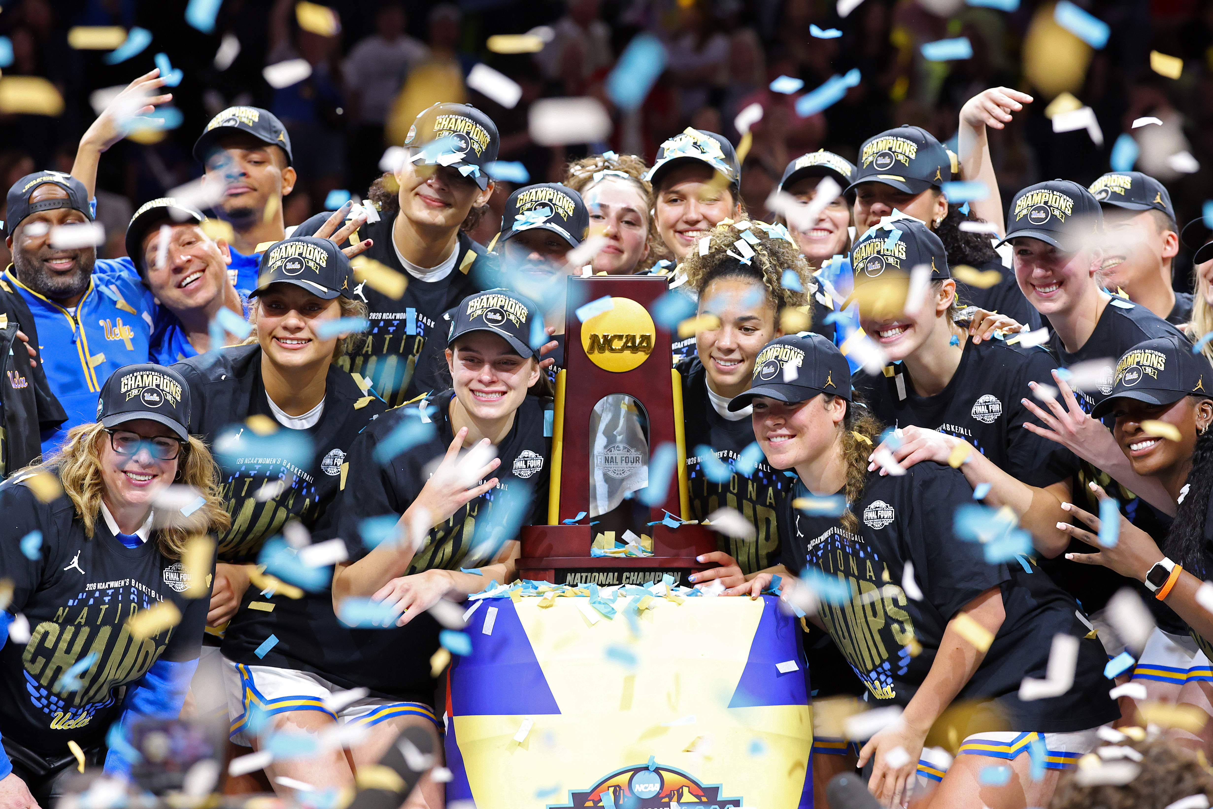UCLA women's basketball team posing with their trophy after defeating South Carolina in the 2026 National Title game