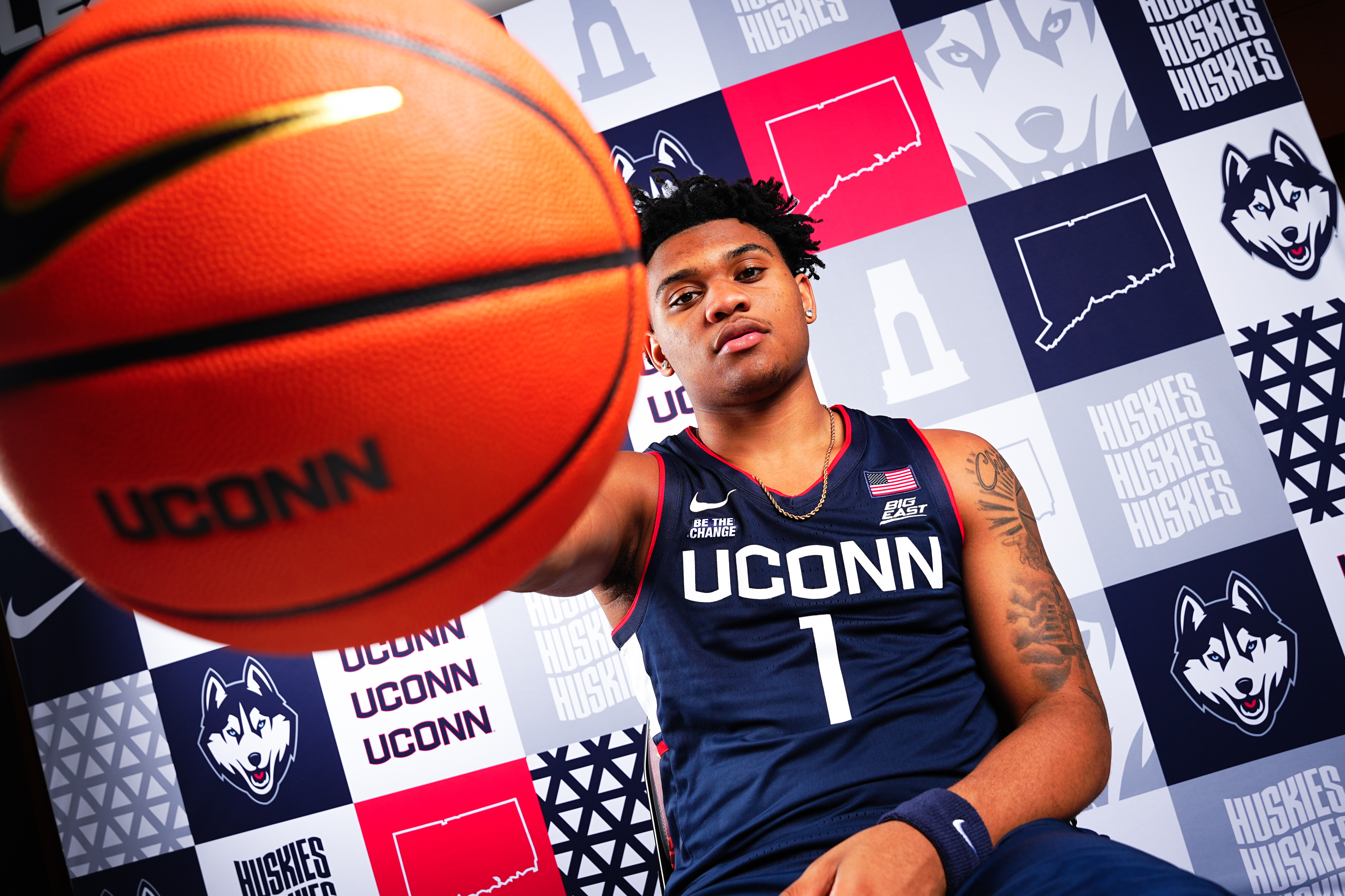 Colben Landrew posing with a UConn branded basketball