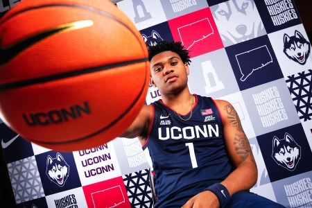 Colben Landrew posing with a UConn branded basketball
