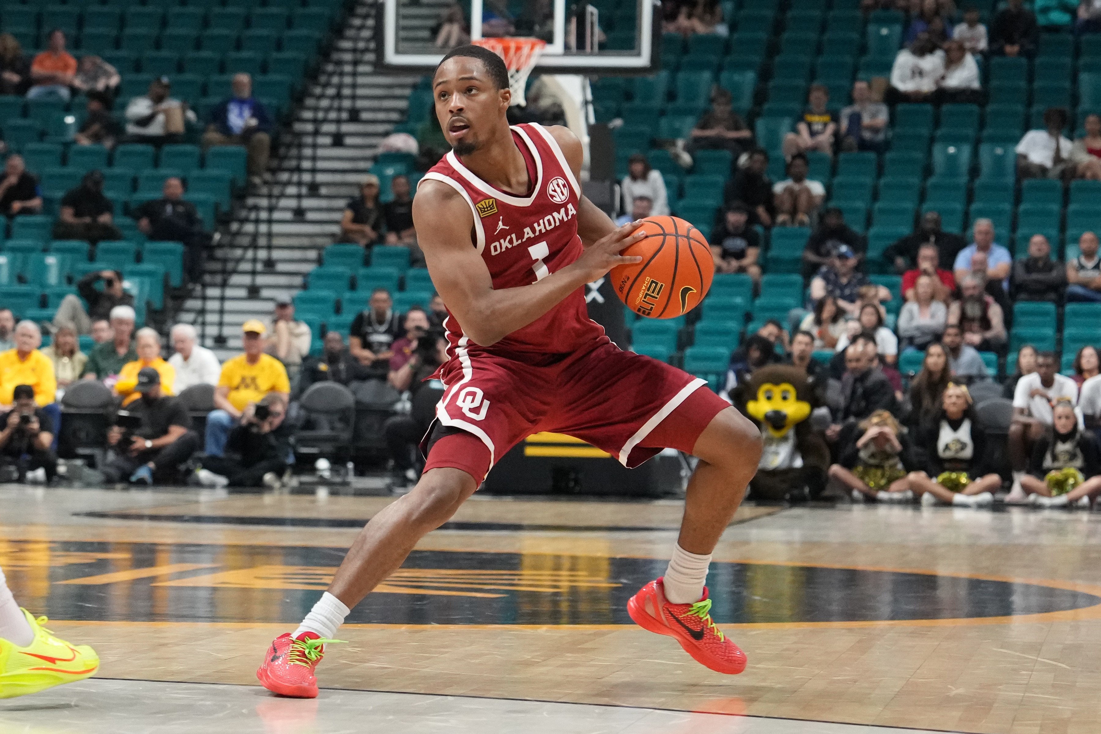 Oklahoma guard Xzayvier Brown dribbles the ball near the three-point line